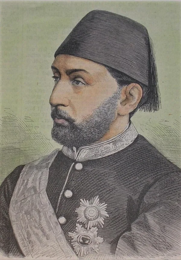Hand-coloured wood engraving of Murad V seen from the side: a man with a short grey-brown beard in a fez and a dark coat with a high embroidered collar, a sash and star-shaped decorations, on a pale green ground