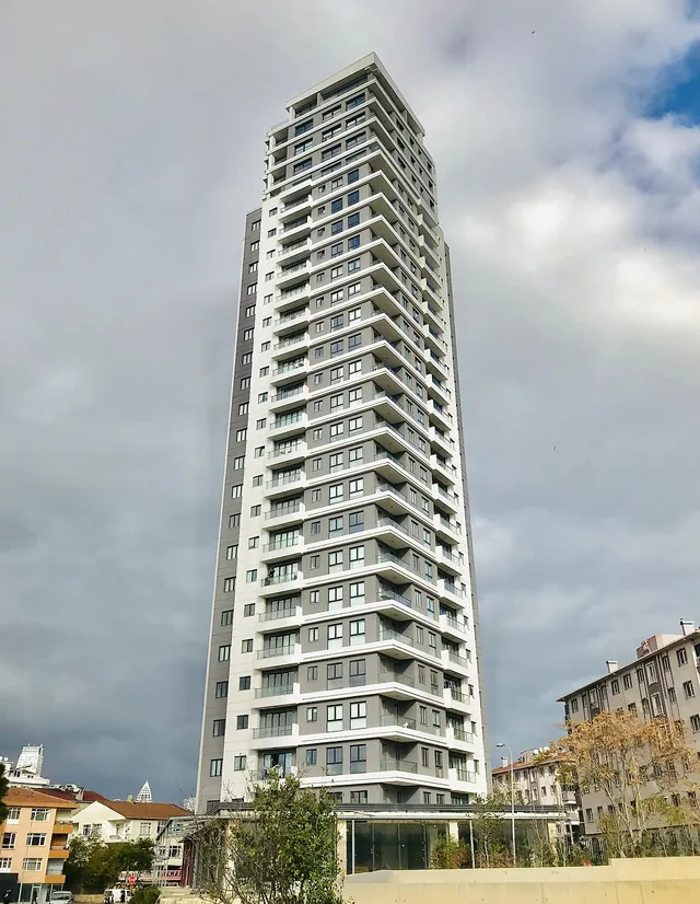 A tall residential tower in Kartal, Istanbul, under a cloudy sky