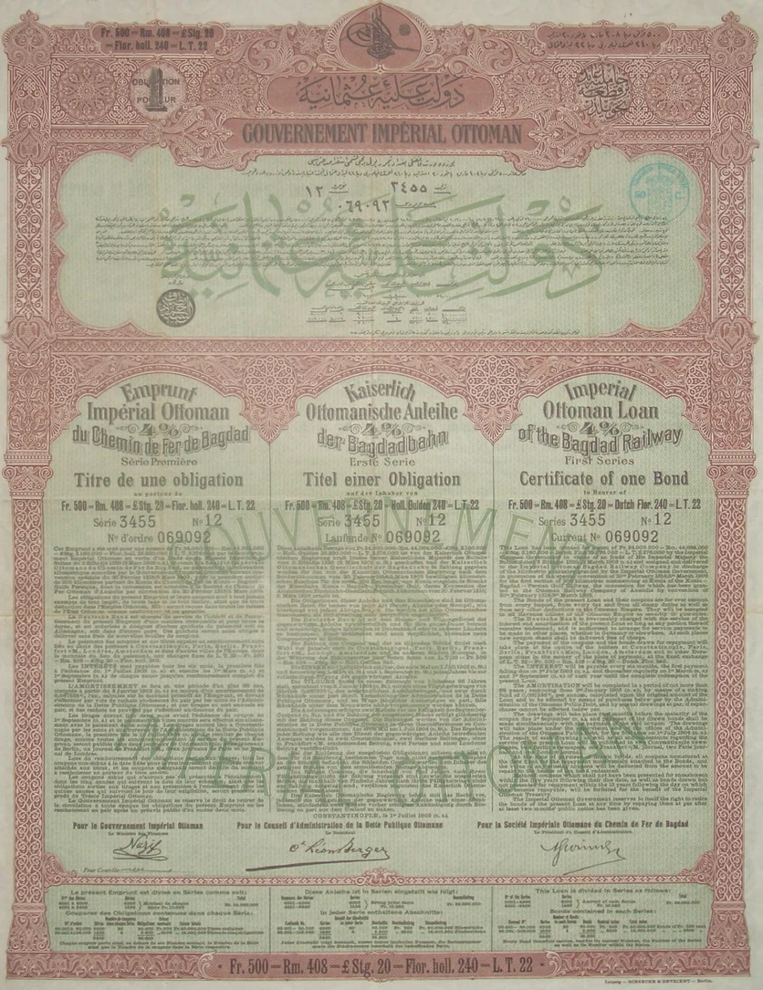 Certificate of one bond of the 4 % Imperial Ottoman Loan of the Baghdad Railway, first series: a tall sheet with a red-brown ornamental border, the sultan's cipher at the top, text in Ottoman Turkish, French, German and English, and three signatures at the foot